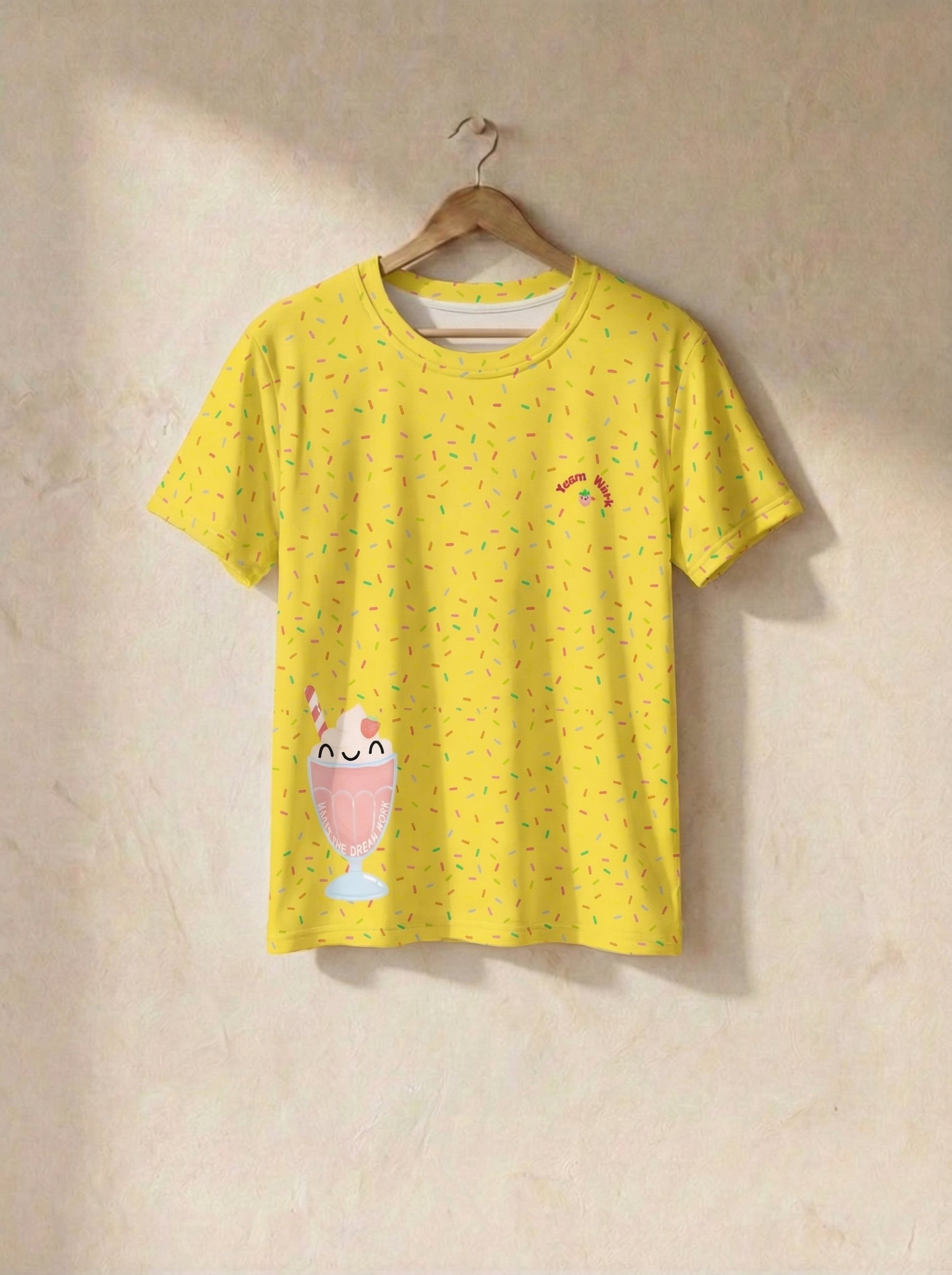 Yellow t-shirt with a cartoon design on a beige wall
