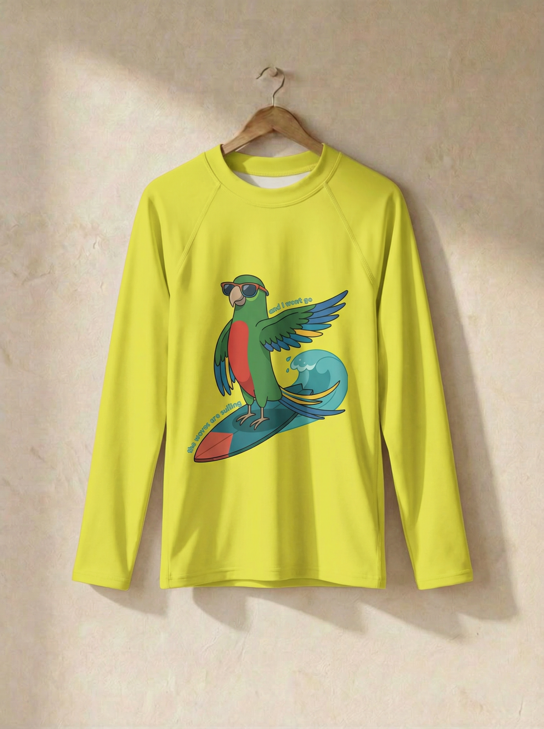Yellow long-sleeve shirt with a parrot design on a beige background